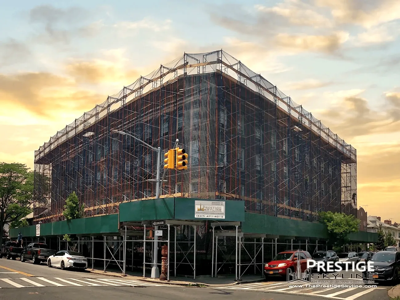 NYC apartment building under full scaffolding during a Prestige Skyline façade renovation at sunset